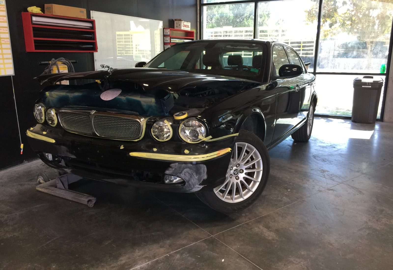 Vehicle staged for bumper repair inside the BumperDoc Santee work bay